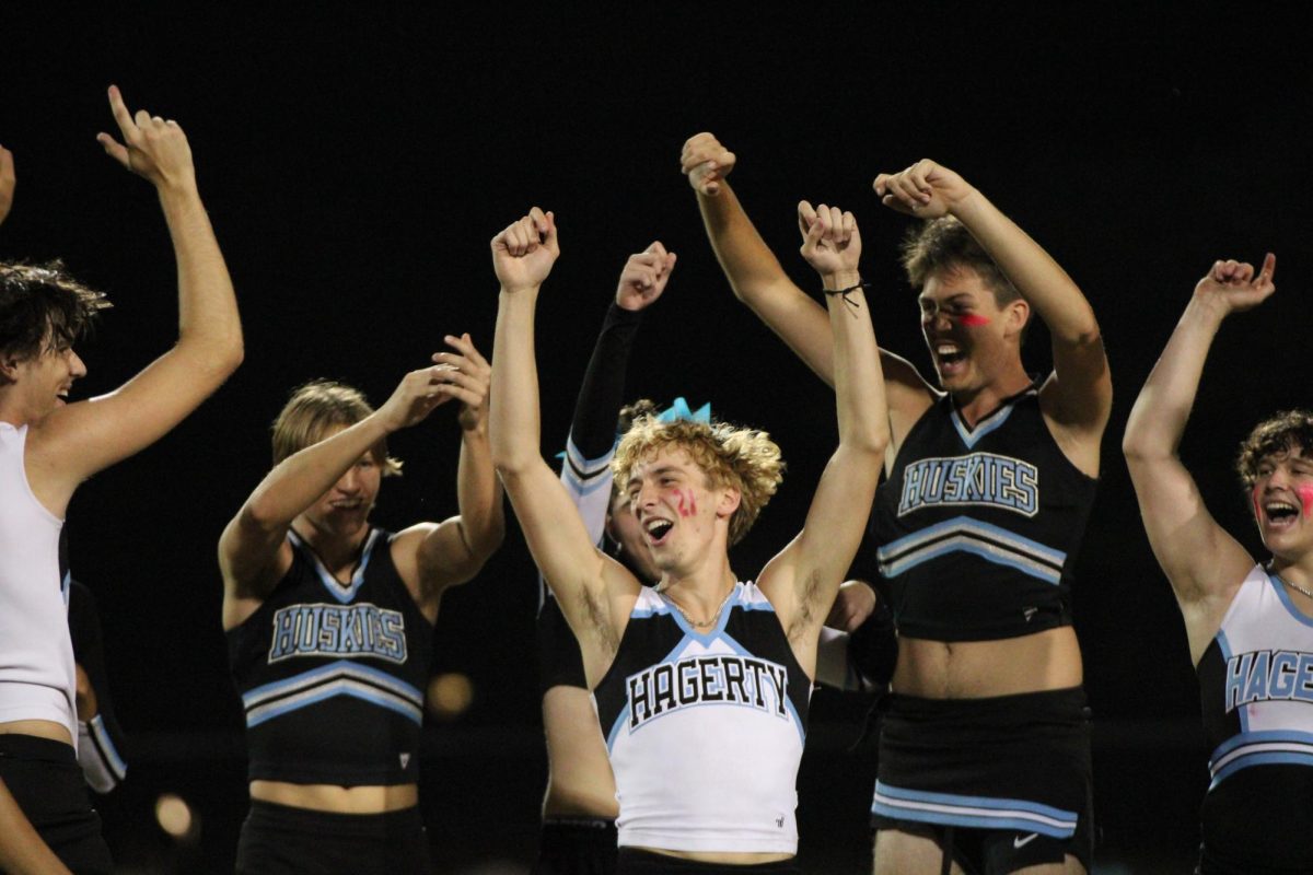 At Tuesday's powderpuff football game, junior Powderpuff cheerleaders Drake Adkins and Nathan Anna perform their halftime routine.  