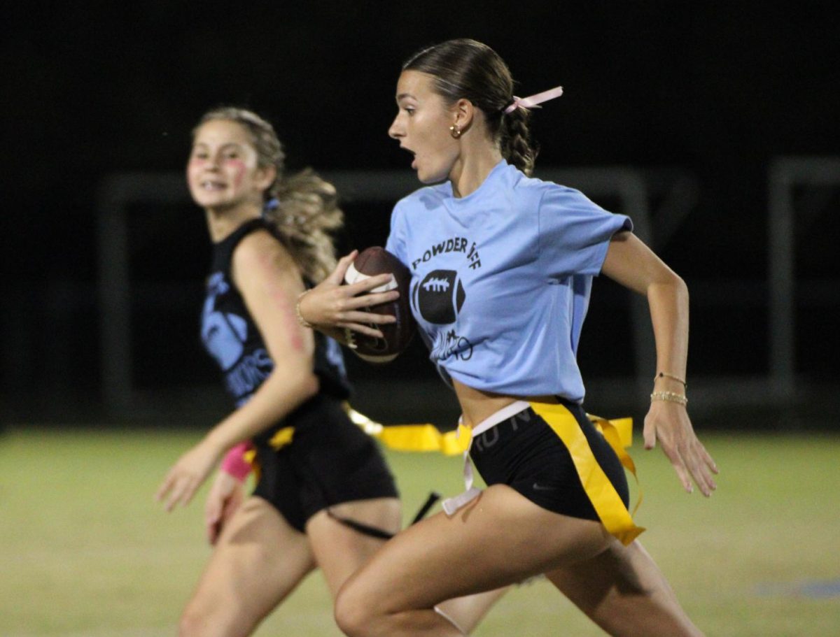 At Tuesday night's powderpuff football game, junior Courtney Dusart runs down the field. The seniors beat the juniors 30-0. 