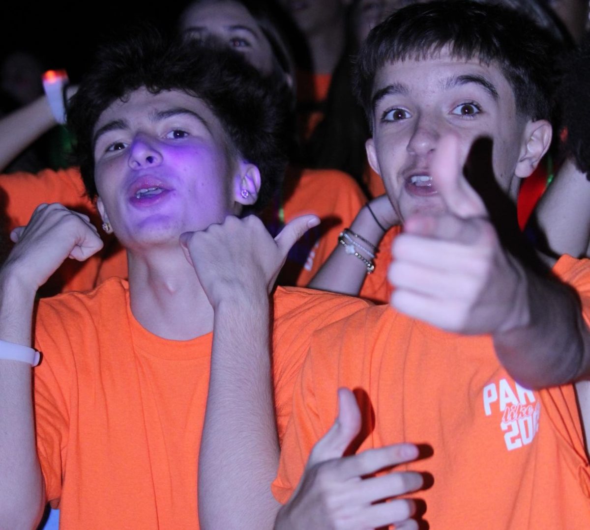 Sophomores Chase Wagner and Ayden Orak cheer during the pep rally. Each grade wore different color shirts; the sophomores wore orange.