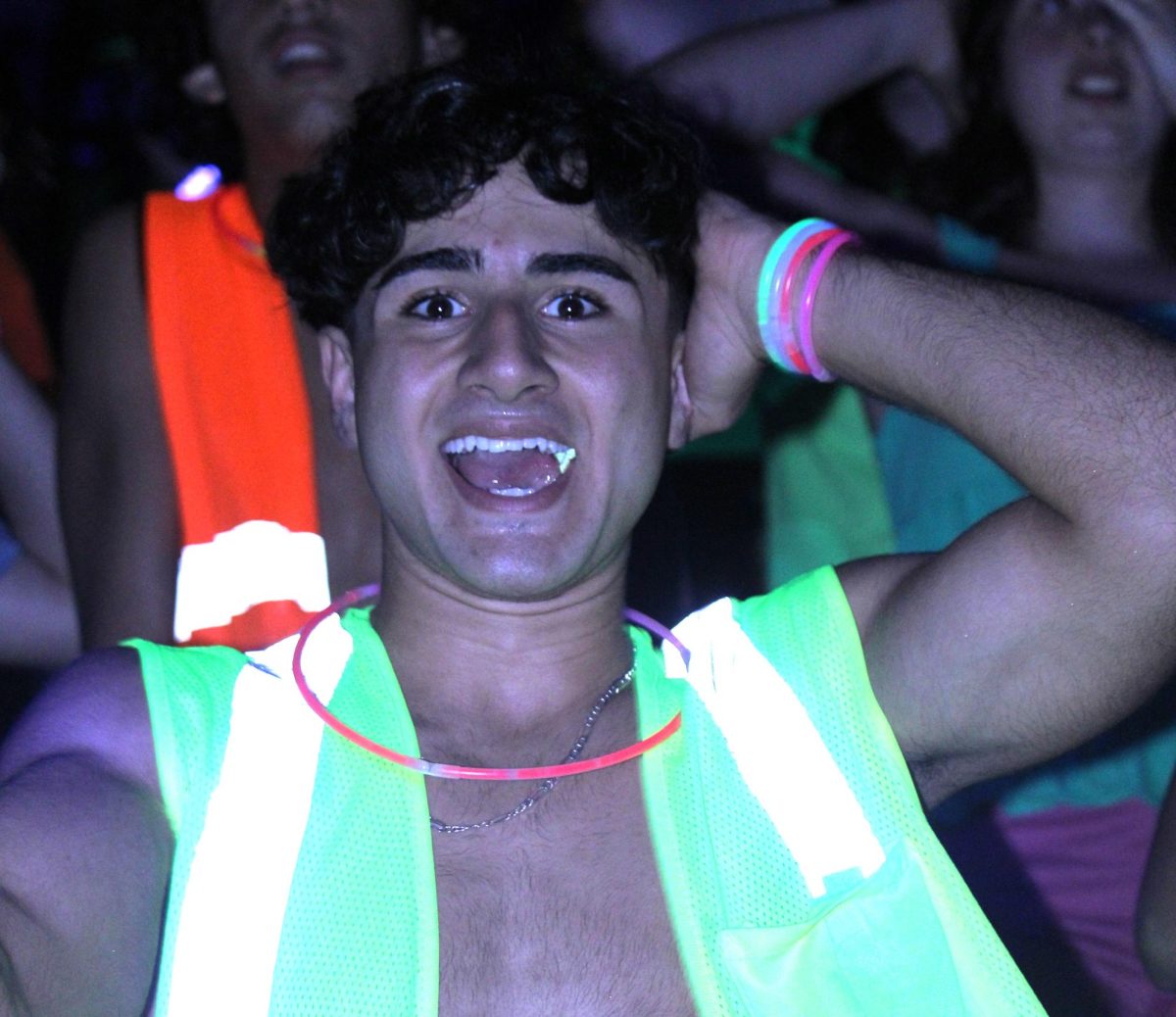 Junior Mohamad Mutawe dances at the Thursday pep rally. Matwe wore a construction vest in order to light up during the glow portion of the event.