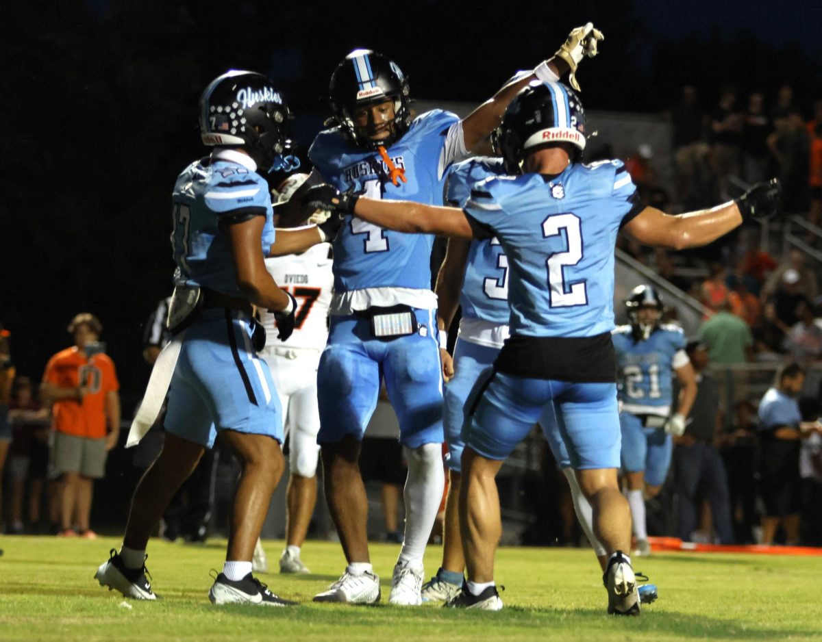 Senior players Jordan Ketron, Bryson Bock, and Brian Tews celebrate after a receiving touchdown by Ketron. Despite a 21-7 lead in the first quarter, Hagerty lost to Oviedo 42-28.