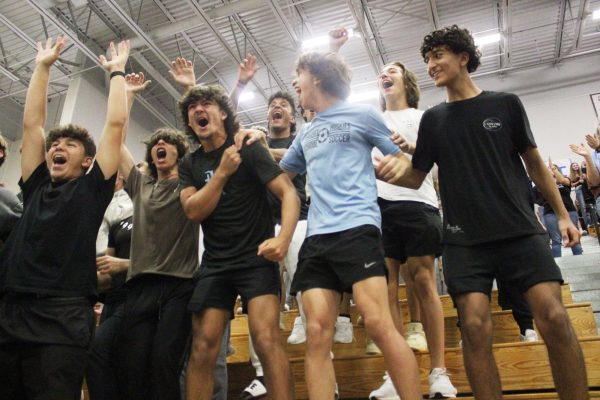 Sophomores Rigo Martin, Lucas Caro and Sam Kimball cheer during the spirit stick battle in the first pep rally. While pep rallies are still the most well-known spirit events, in the past years there has been a decrease in school spirit through a lack of student participation and attendance.