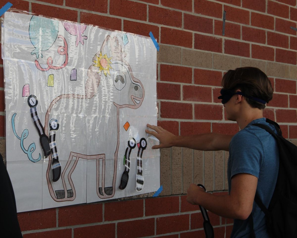 Students play pin the tail on the donkey during lunch. Latinos in Action hosted a game day event to celebrate Hispanic Heritage month.