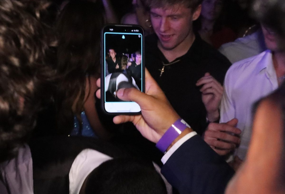 Dance attendees take selfies during Saturday night's event. The dance started at 7:30 p.m. and ended at 10 p.m.