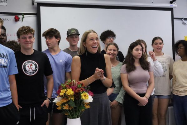 English teacher Jaimie Ling receives flowers during her announcement as Teacher of the Year on Monday, Oct. 7. Ling was surprised by administration, her daughter and former teachers she had worked with during her midblock class.