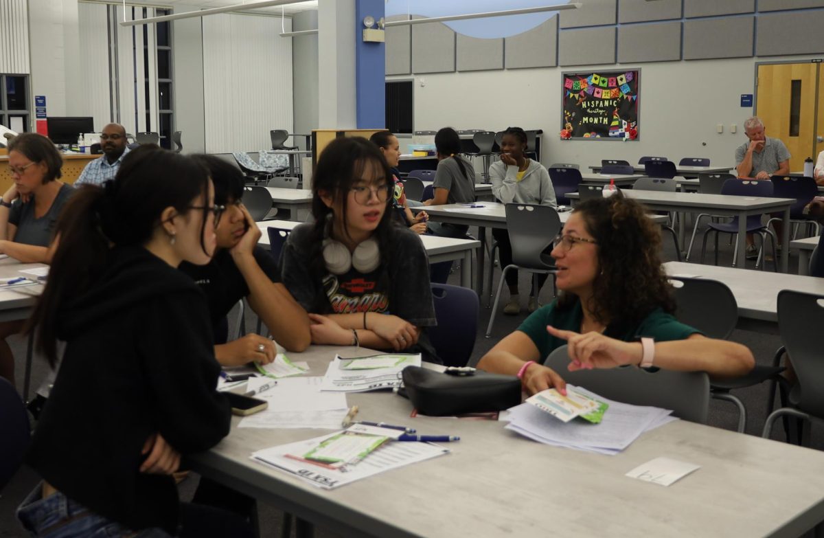 Seniors Hannah Jiang and Huixin Chen listen to advice from TRIO connection speaker Melissa Rosa-Alvarez. TRIO connection and Hagrety's College and Career center plans on hosting a FAFSA workshop January 28.