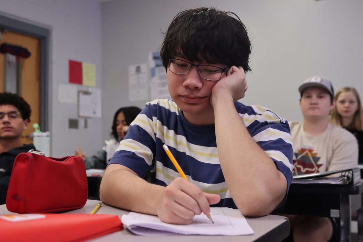 Junior Benjamin Keast works on handout for AP Pre-calc, a common math class taken by juniors.