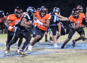 Senior Jalon Lewis runs the ball during the first half of the homecoming football game against Seminole. The team lost the game 42-7.