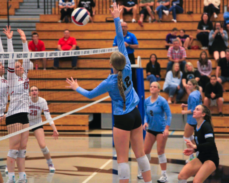 Outside hitter Makayla Miessler attacks the ball in a regional quarterfinal against Creekside on Oct. 23. Miessler was a big factor in the Huskies win.