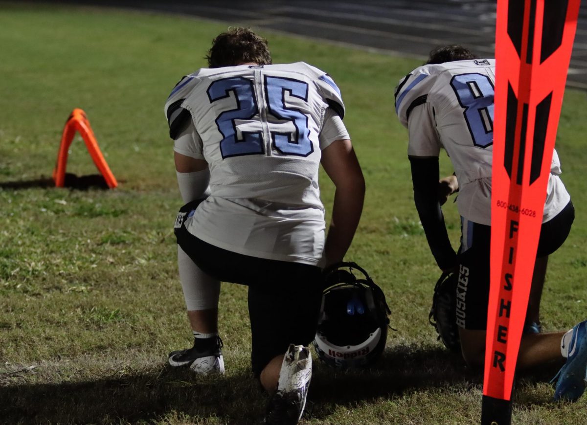 Linebacker Kyle Galarza kneels during a timeout in the Lyman game. Lyman beat Hagerty in the final game of the season, 21-14.