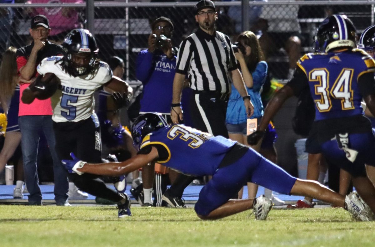 Senior Jalon Lewis breaks a tackle during the first half. Lewis and senior Porter Williams both had strong rushing games in the loss.