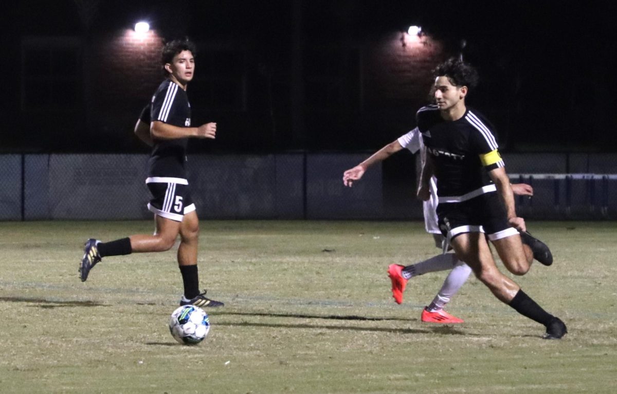 Junior Mohamed Mutwe runs after the ball during the Lake Howell game. Mutwe serves as captain and midfielder on the team.