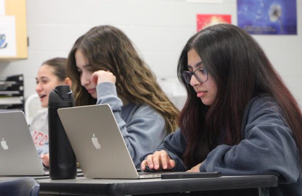 Juniors Gulce Kilic and Jihan Bentaj and senior Guadalupe Maggio work on their projects during the AP Research period. In this class, students write their research paper and have to present their findings.