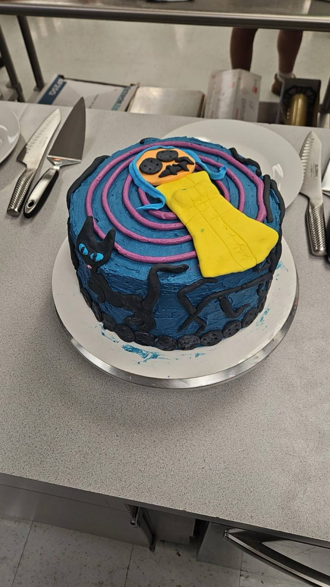 The Coraline cake made in fourth period contains characters and elements of nature crafted with fondant. The colorful rolled-out icing covered the majority of the cake.