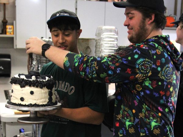 Junior Keano Vega and senior Jackson Ricks assemble their Terrifier 3 cake to present to the judges.