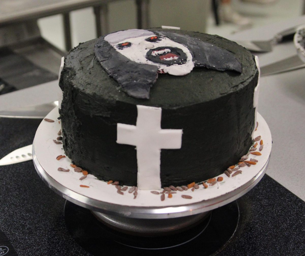 The Conjuring cake made in third period makes use of fondant pieces to create the cross and terrifying face of a nun from the film.