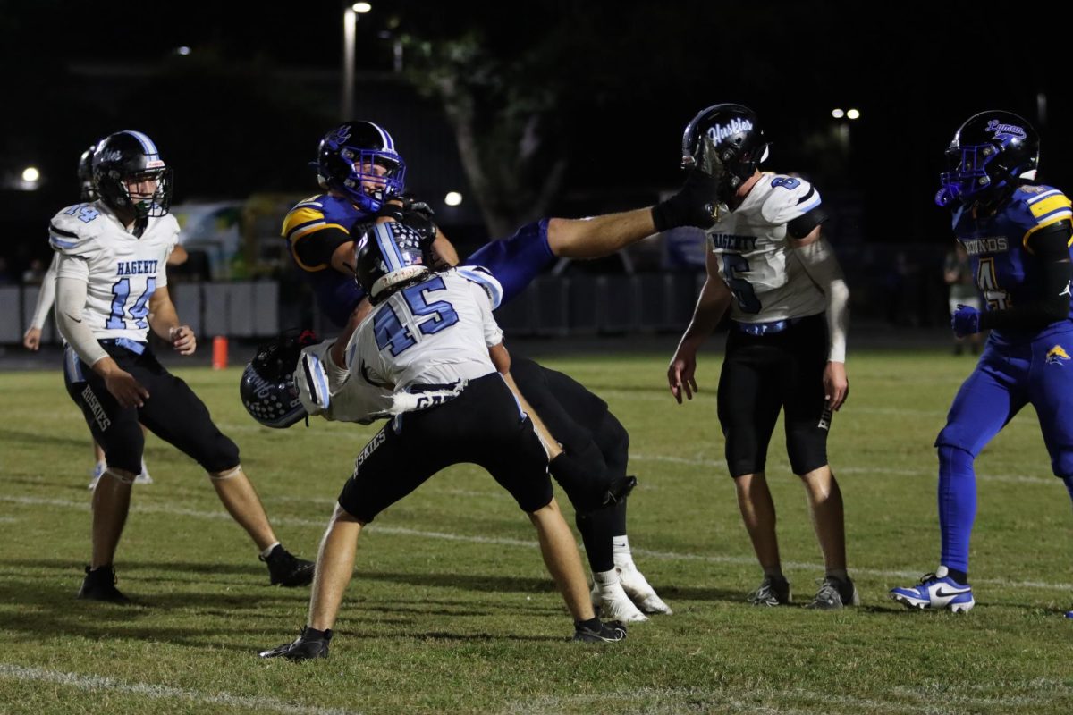 Sophomore Colton Hatfield holds off the Lyman offense. The team lost 21-14.