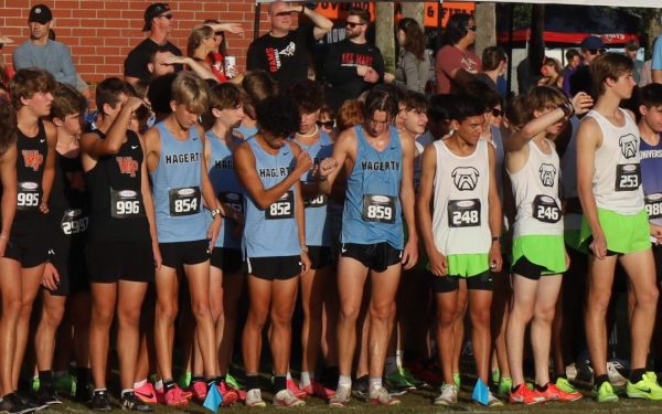 Seniors Jacob Leon and Connor Stromberg share a fist bump before the start of their 5K race, hoping to top their personal record and earn district medals.