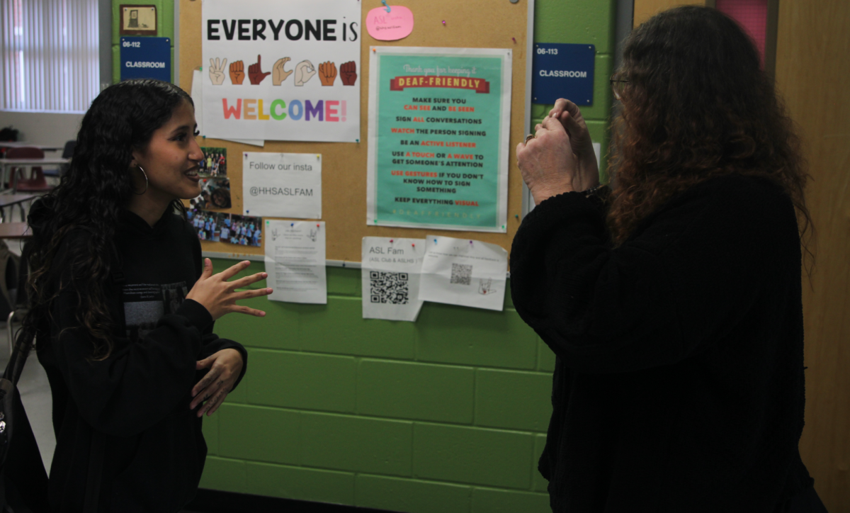 Junior Jiana Velez signing with ASL teacher Barbara Chaves. Velez is a member of Chaves's ASL 5 class.