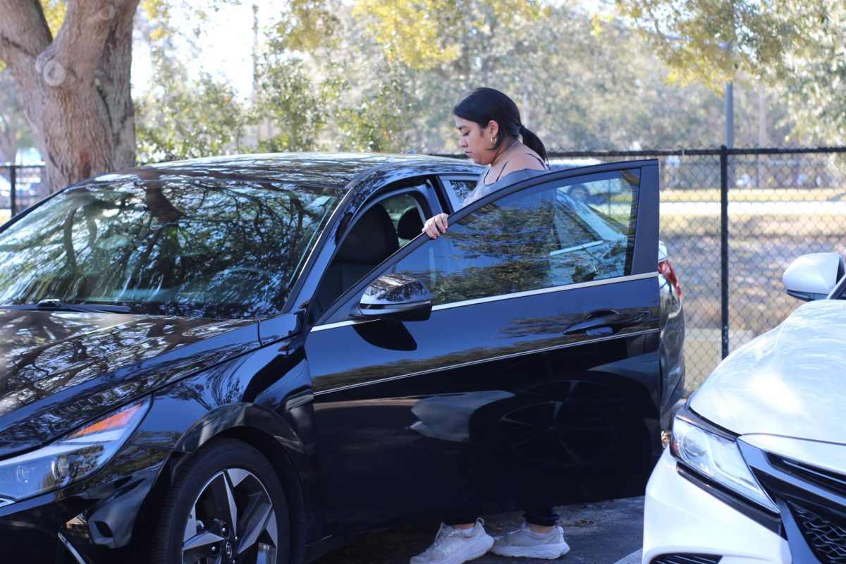 Adaara Alli gets in her car parked in the student parking lot. Students have to pay $80 for a parking pass.