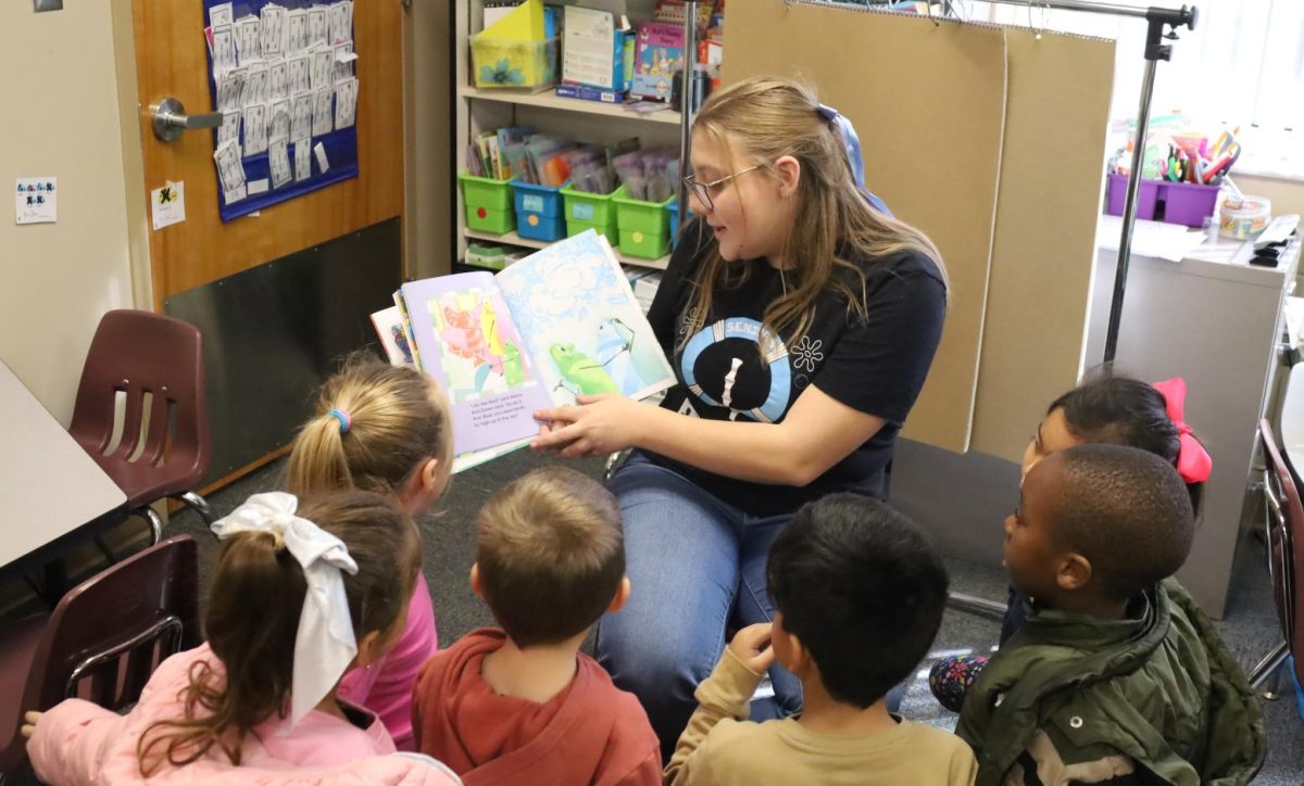 Senior Danielle Hoffman reads to Carillon Elementary kindergarteners. This field trip was in celebration of Literacy Week, and students were nominated in order to attend.