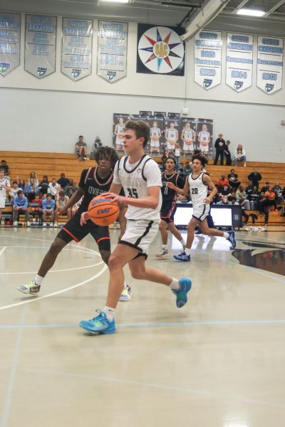 Junior Asa Kohn dribbles the ball down the court in a 58-47 loss to Oviedo.