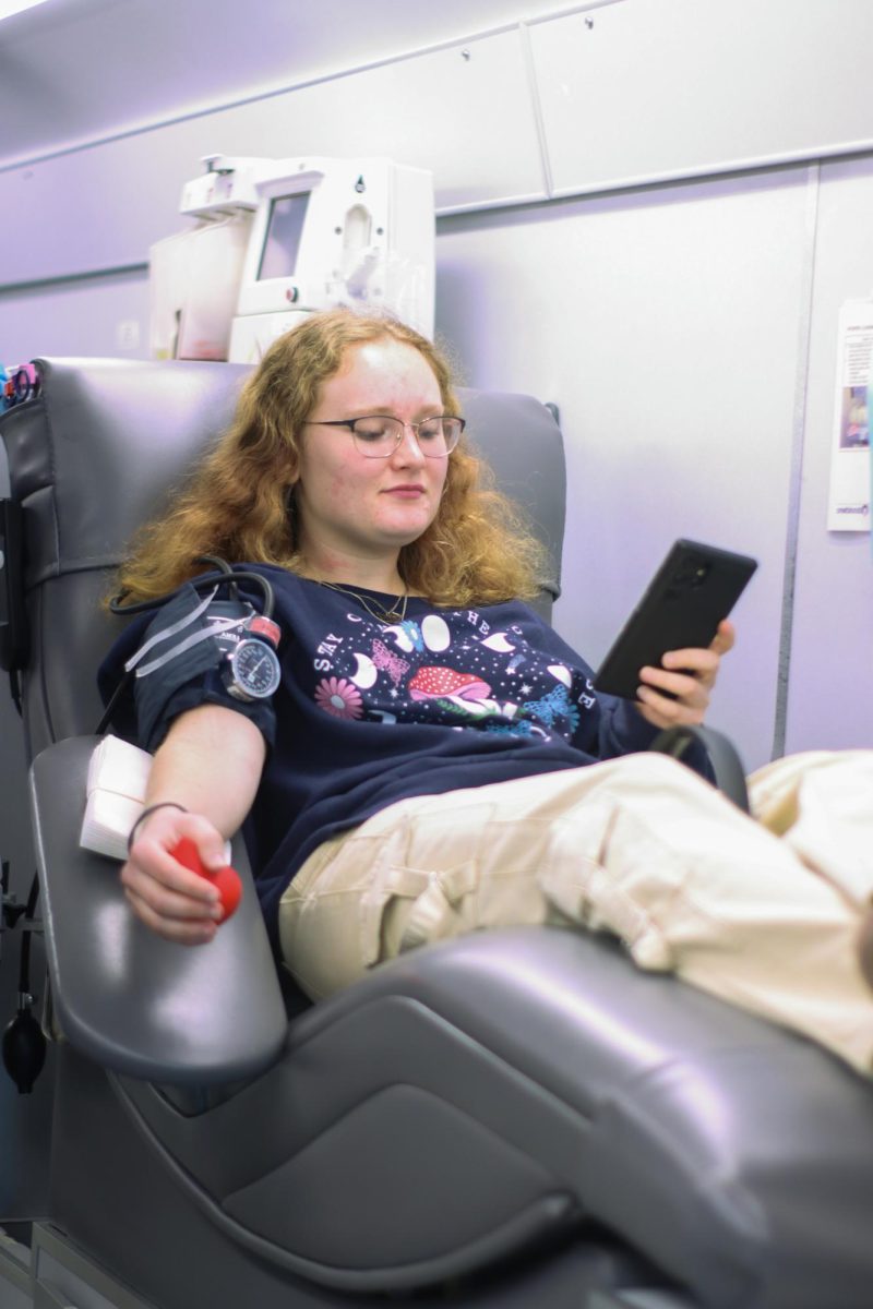 Senior Ali Jacobs getting blood drawn. The ball Jacobs is holding helps promote blood flow and decrease the risk pf fainting.