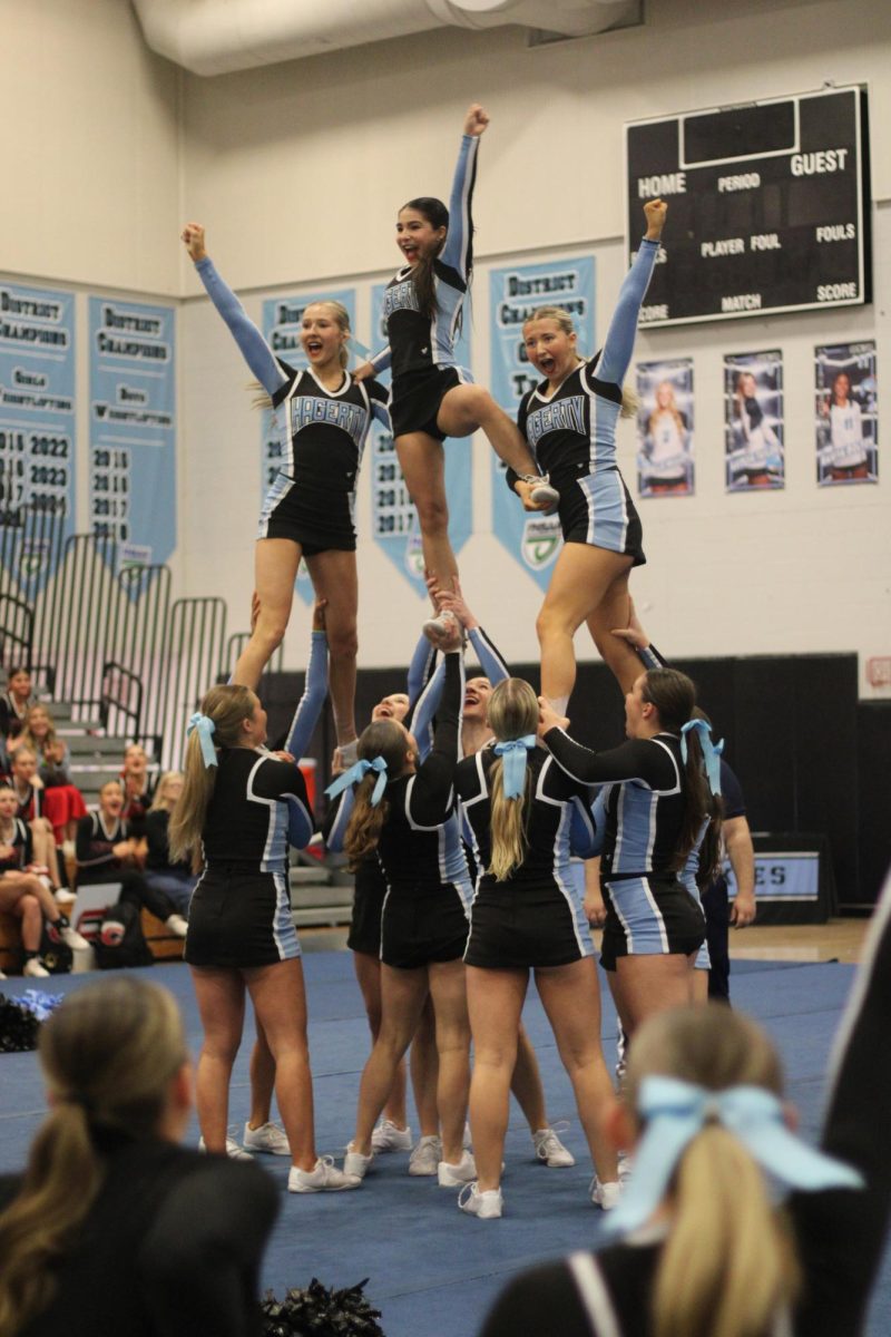 Members of the varsity cheer team perform at regionals in the Hagerty gym on Saturday, Jan. 19. The team took first place with a score of 84.9 points and will compete for a state title on Feb. 1.