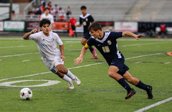 Defender Christian Cancel fights for the ball at a preseason game against University on Jan.1. Hagerty lost the game 4-0, however the team was able to beat University when they met again for district semifinals.