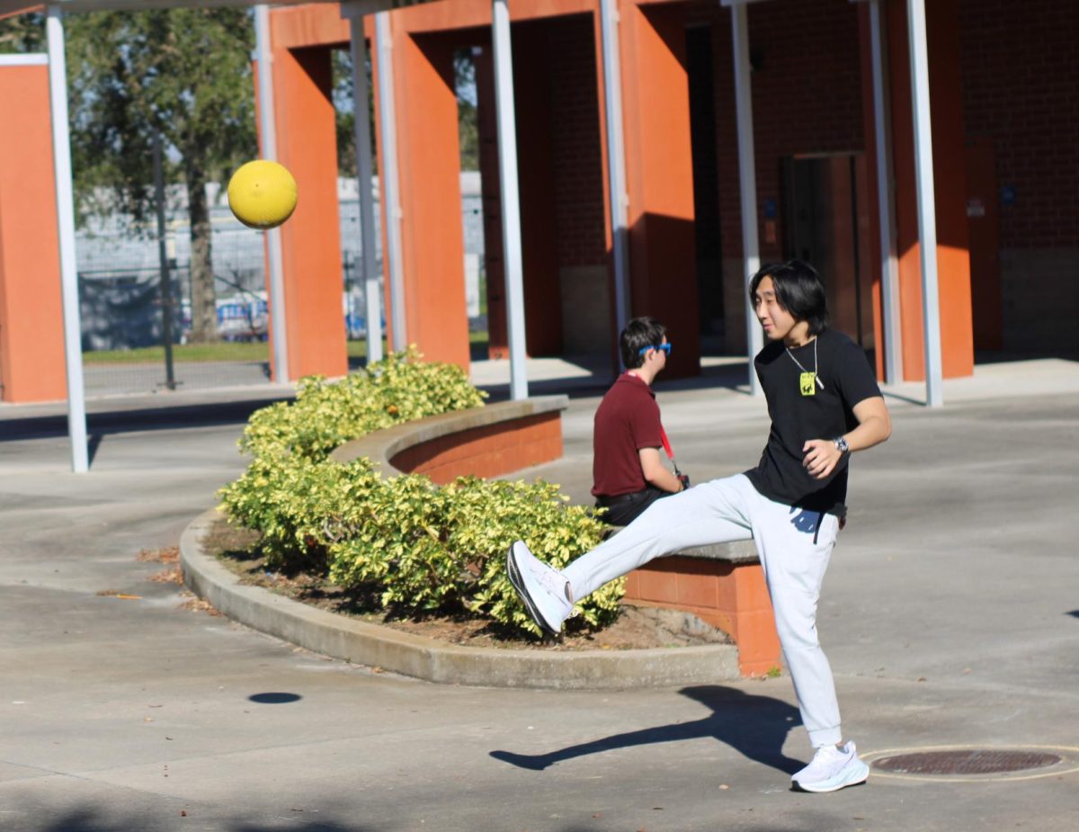 Junior Darren Nguyen participates in the Best Buddies kickball game. 