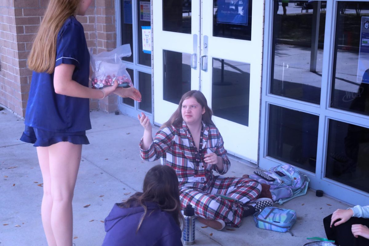 Wednesday: "Sweetheart Sleepover." Senior Taryn Baker is given candy for wearing pajamas. Leadership members handed out Hershey Kisses for students wearing pajamas to encourage others to dress up. 