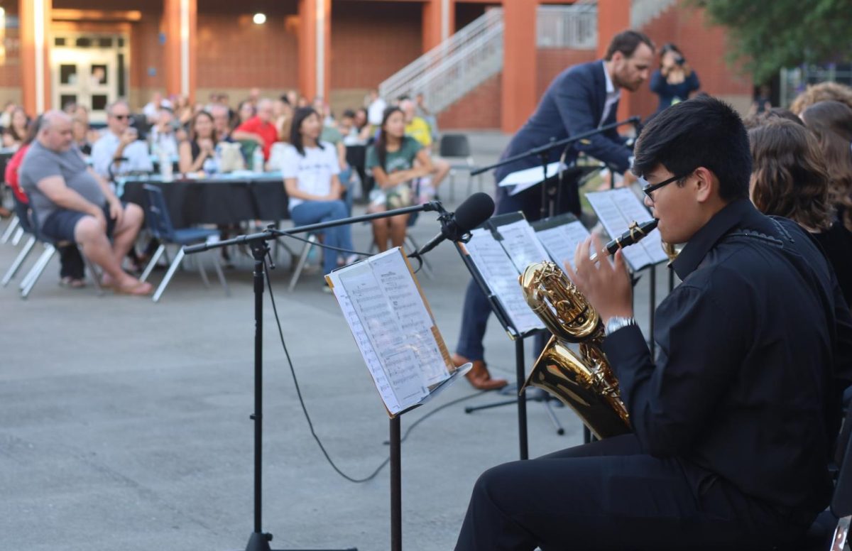 Freshman Ian Monreal plays the saxophone with the rest of the ensemble. The event took place in Hagerty's court yard on April 23.