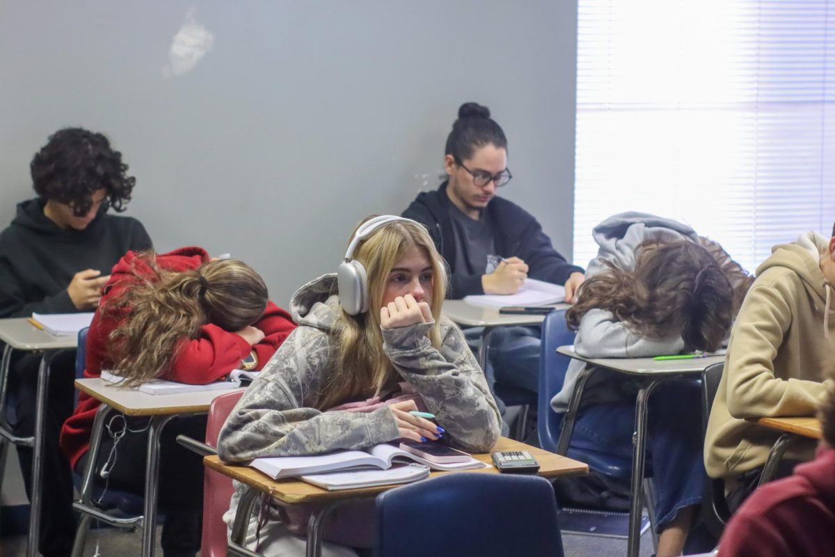 Students in math teacher Steven Mikles's class doze off, while sophomore Kate Zielke looks up at the lesson. Students fell behind--especially in math--as a result of the pandemic, both in motivation and academic skill.