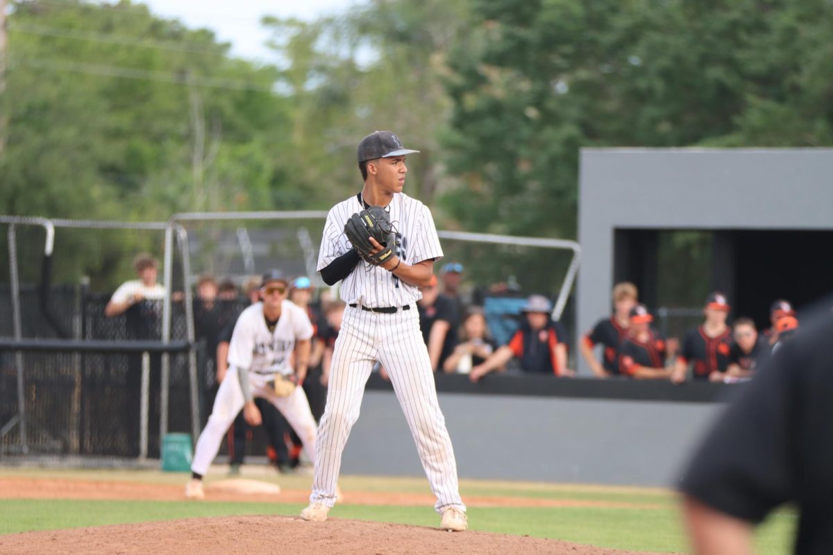 Noah Adkins preparing to Throw a pitch.