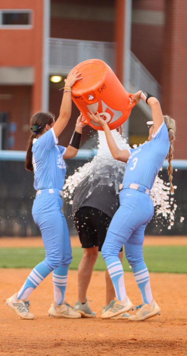 Players dump ice cold water on their coach. 