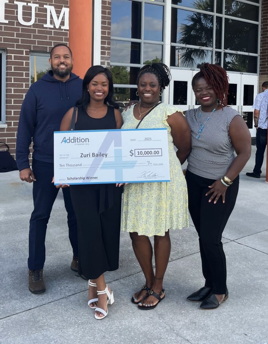 Senior Zuri Bailey poses with a check from Addition Financial. Over 70 students were recognized on May 1 at the scholarship breakfast.Photo by Zuri Bailey.