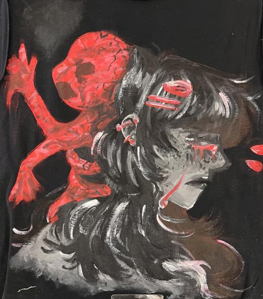 Inspired by the movie Malignant, Strzalko painted a disturbing separation of a girl and the demon coming out of her head on a T-shirt. She wanted the demon to stand out so she used different shades of red to color it and made the girl black and white in order to direct as much focus to the horror part of her artwork.
