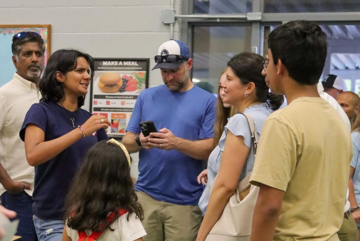 Junior Idika Banerjee educates a group of parents and peers about the Young Democrats Club. Anyone who attended Pack Preview was encouraged to approach club leaders at their stands to ask them questions. 
Photo | Michaella Tixiera