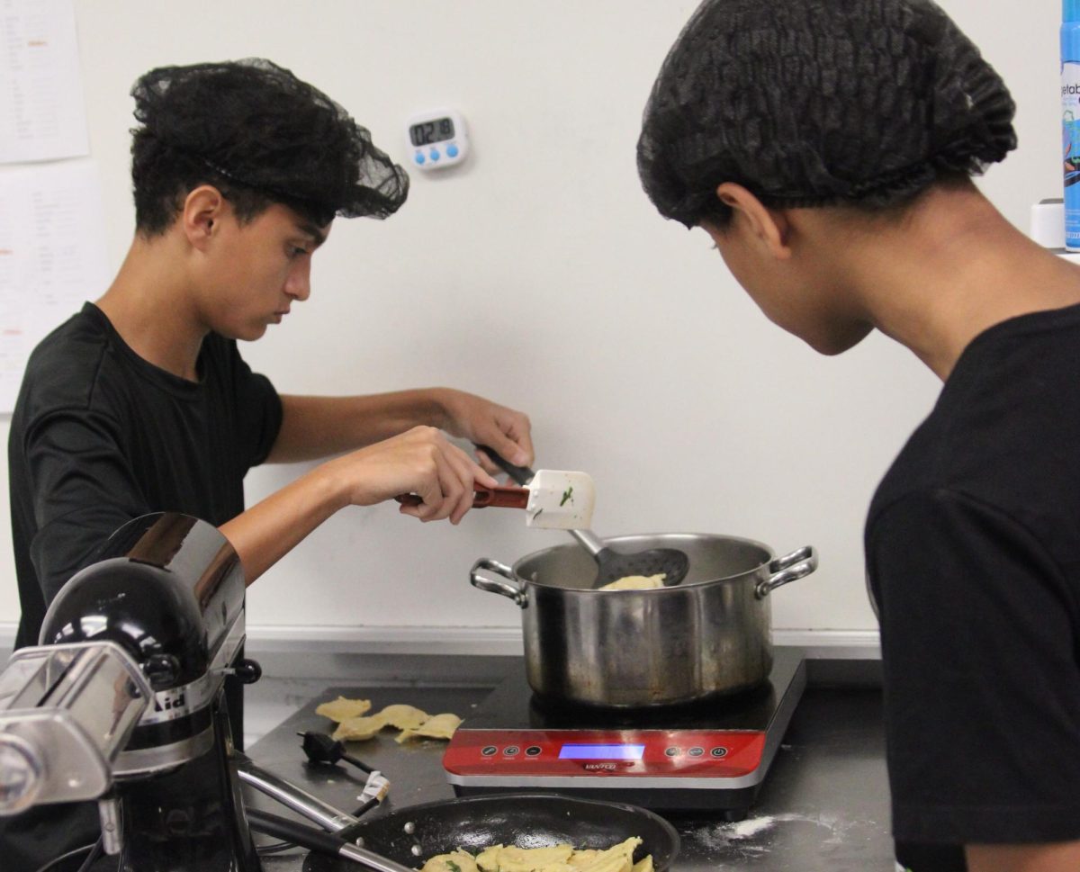 In last year's Culinary II class, sophomore Colton Ong mixes batter during a pumpkin lab. Administration is currently interviewing to fill the teaching vacancy left left by Ellen Pesce at the beginning of the year.