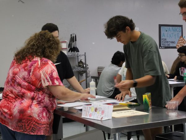 Long term substitute Cheryl Orlando helping a student with assigned work