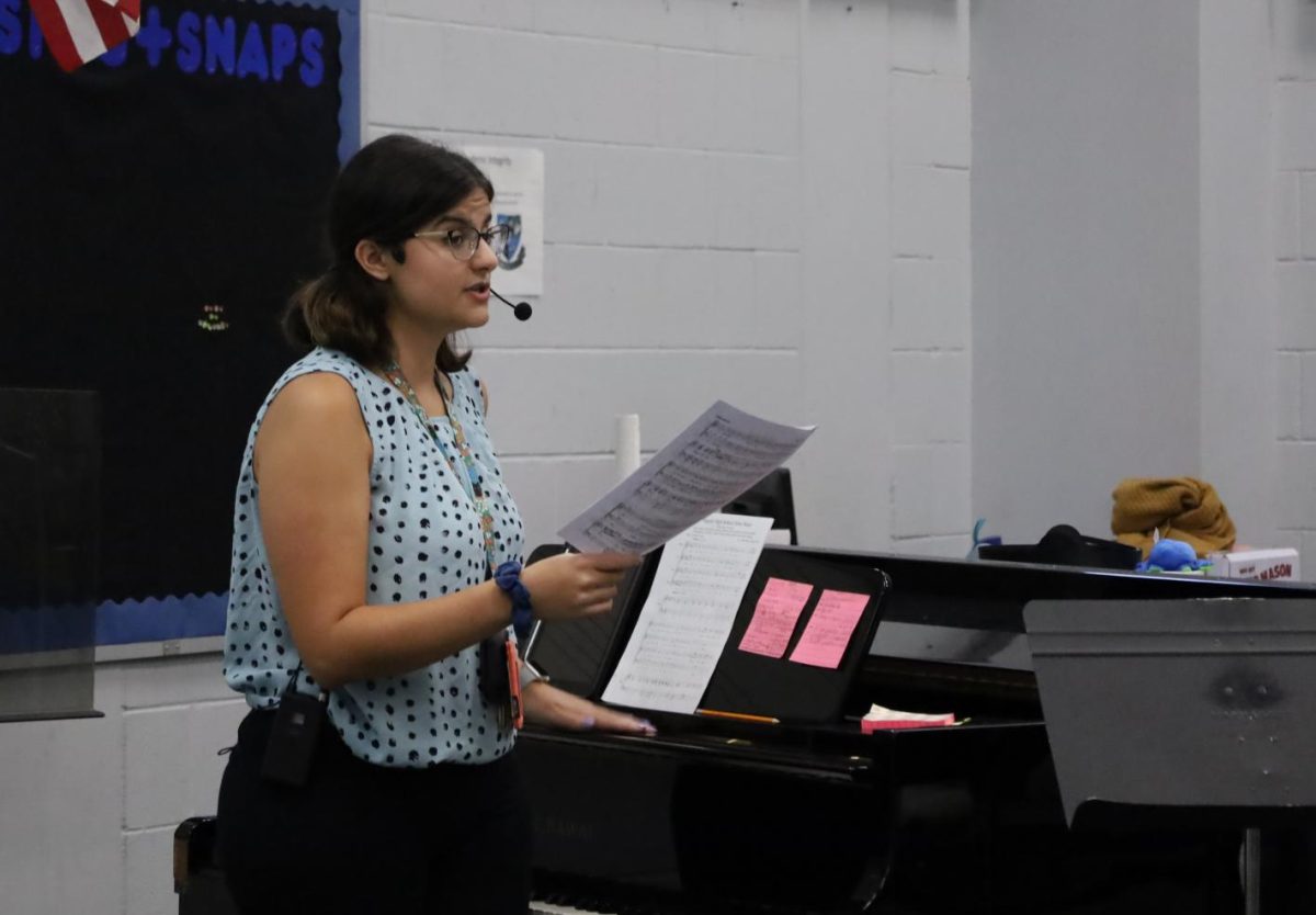Choral director Kayla Tassone conducts her chorus class as they sing. Tassone joined the choir program this year, and has quickly been welcomed in by the students.