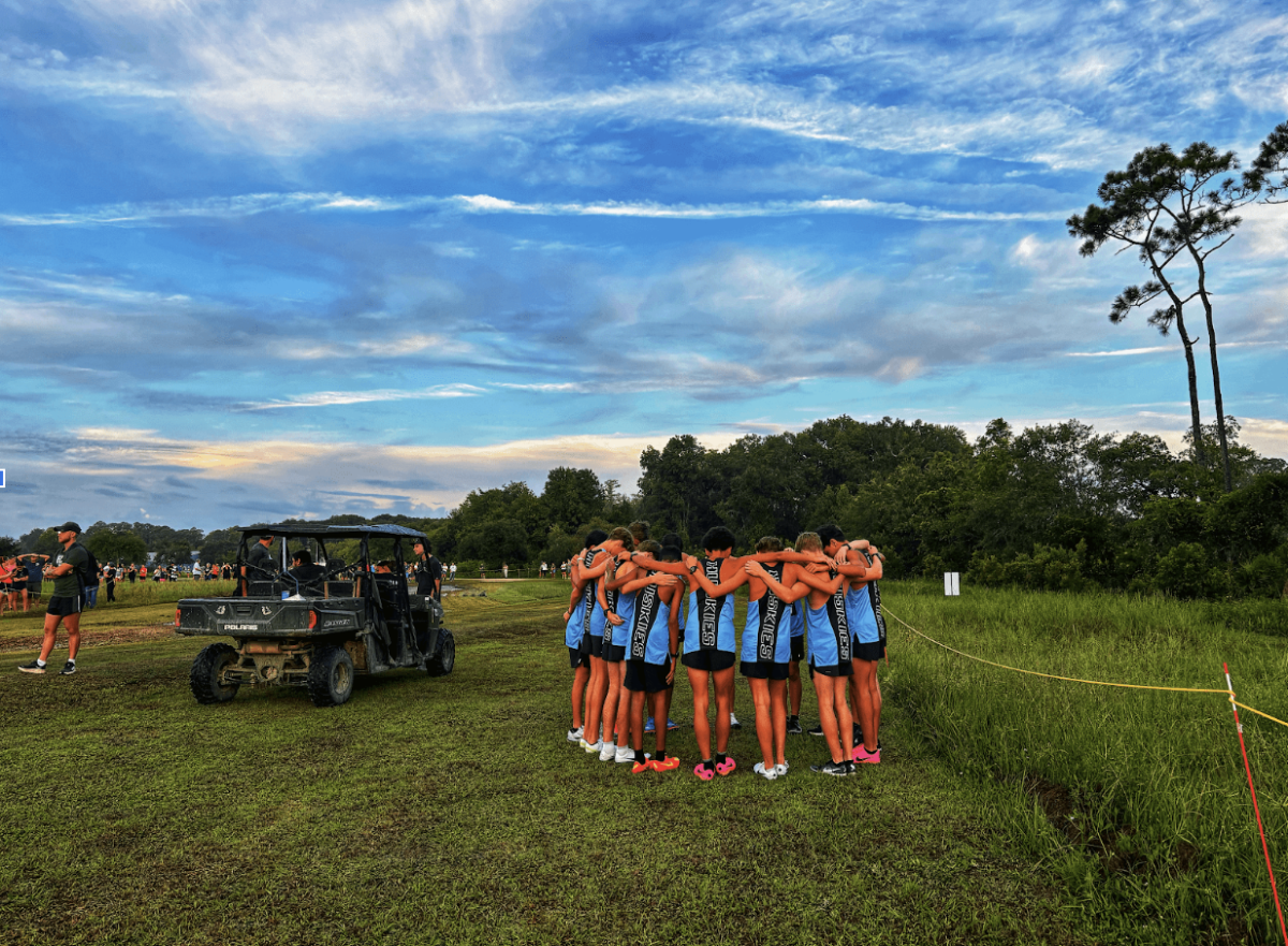 The boys cross country team huddles up before their race. 