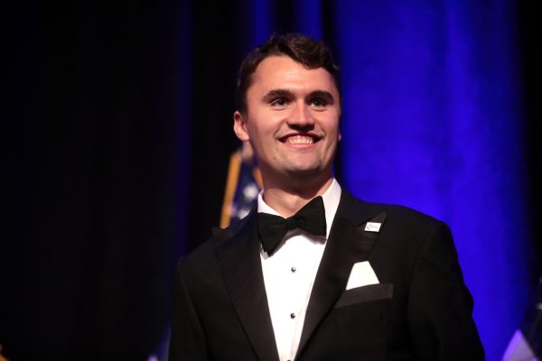 Charlie Kirk pictured on stage during a speech