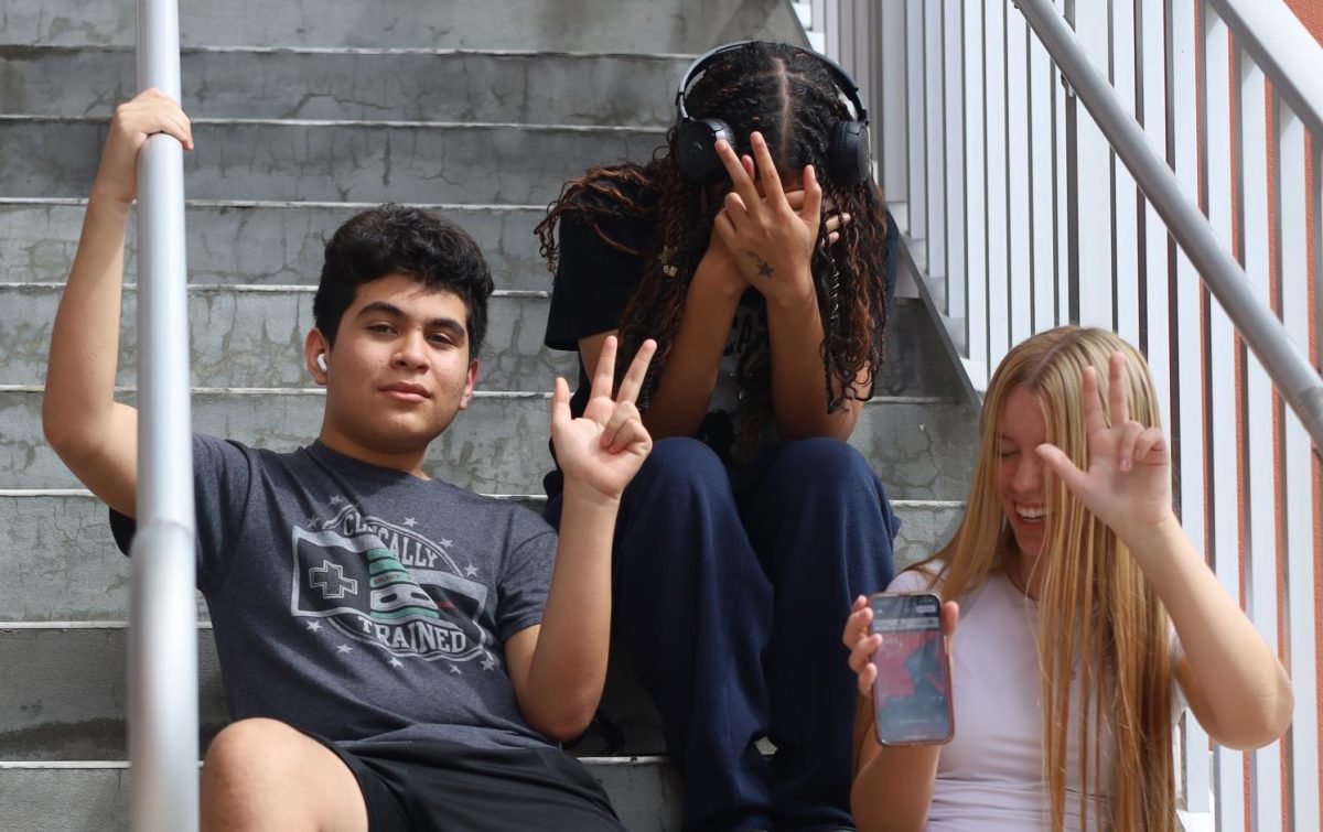 Local Vamps throw up the YVL. Vamps can be spotted everywhere on campus, even in the stairwells. From top to bottom: Daniella Barnett (12), Elijah Manrique (11) and Sadie Maxwell (11)