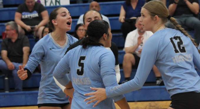 Senior Isabella Cruz celebrates with teammates as Hagerty takes the second set of the game.