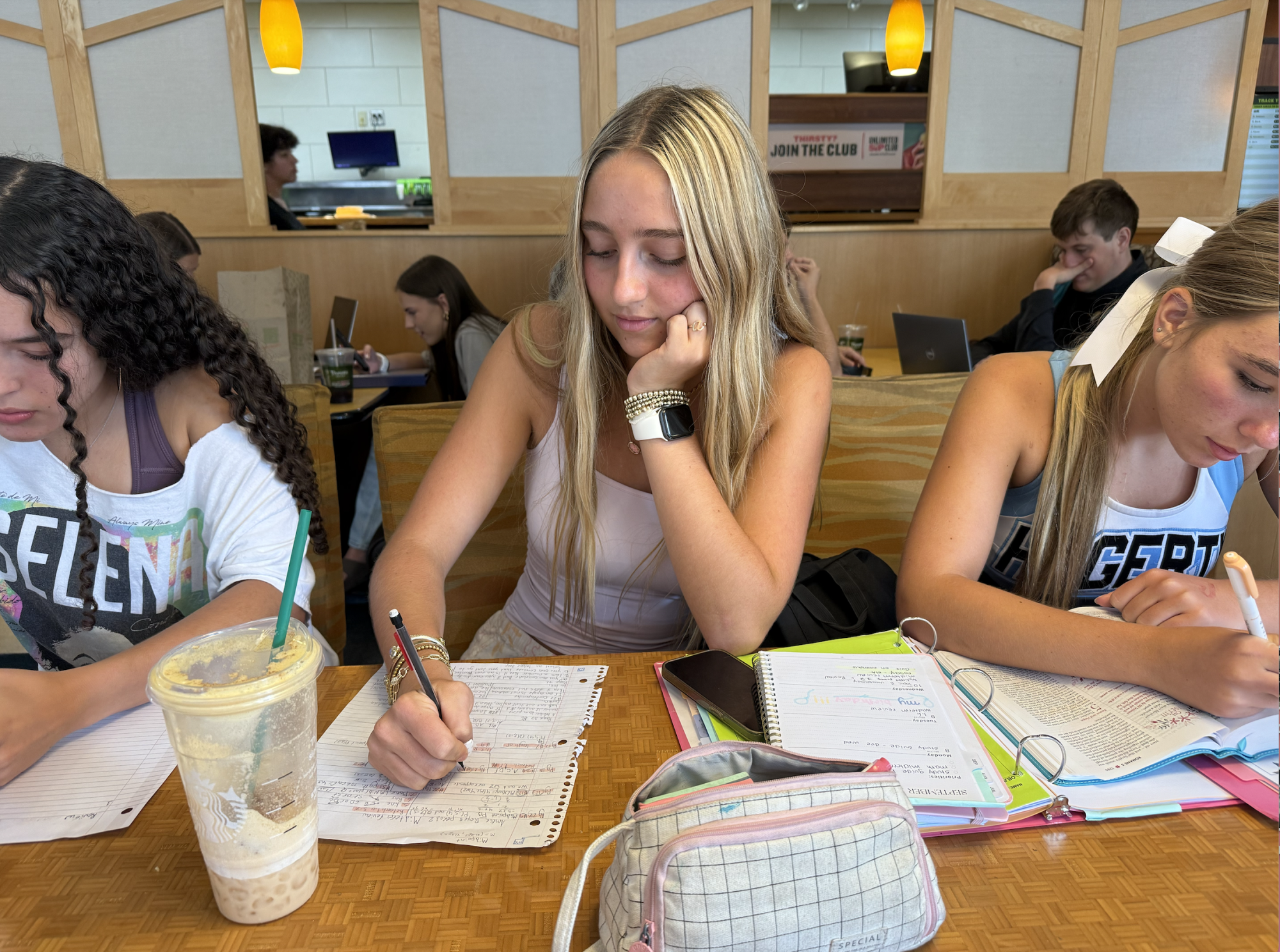 Freshmen Isabella Zimmerman, Amelie Reyes, and Bella Reynolds studying at Panera. 