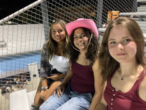 Juniors Maja Rothe, Fiorenza Dellepiane and Laila Rolon are watching the varsity football game against Lake Toho on September 5. Rothe loved the high energy and festive theme found in the student section. (Photo by Maja Rothe)