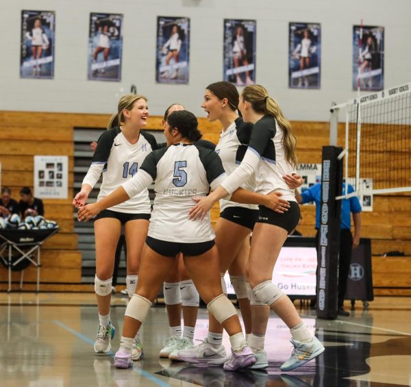 The Huskies celebrate after a point. 