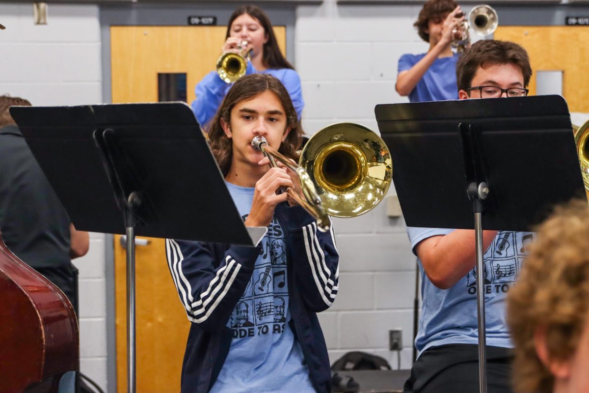 Freshman Witt Wood warms up on his trombone before his jazz class begins.