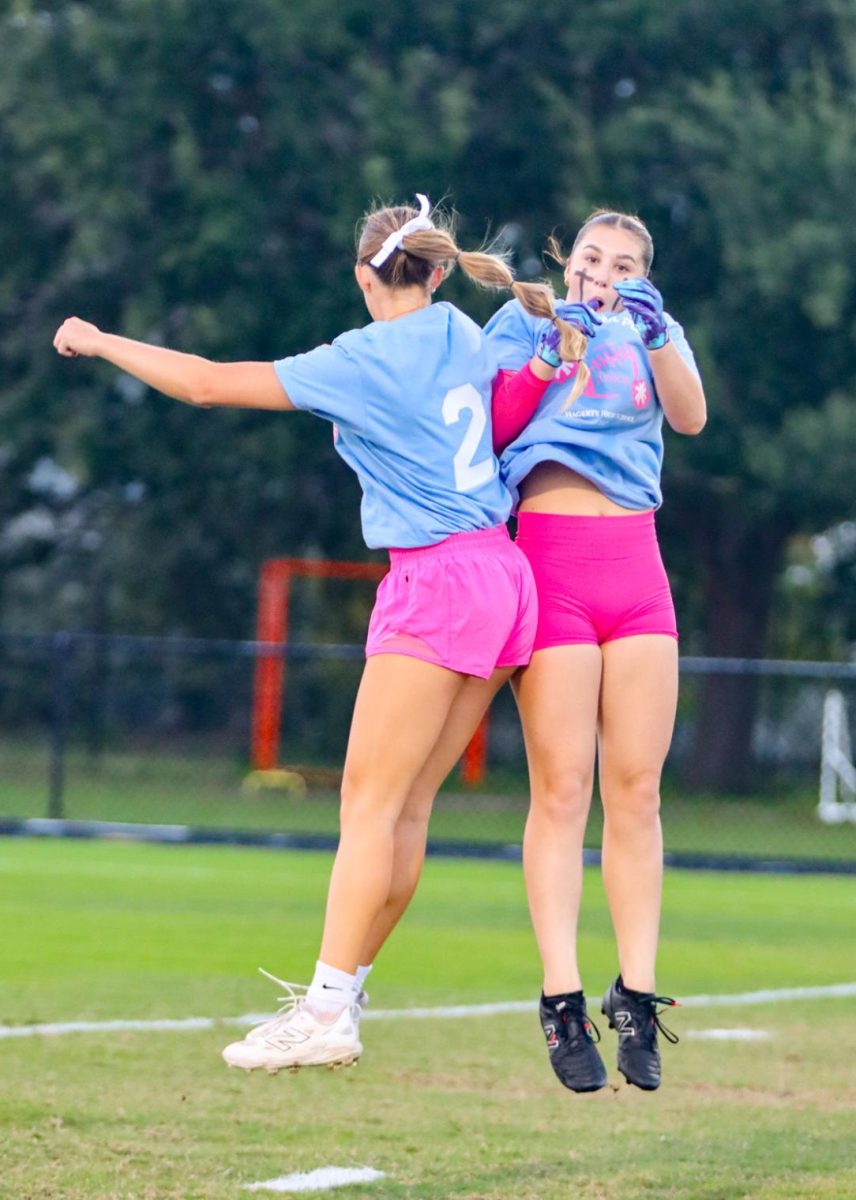 Alina Gallaher and Jillian Zinnert jump together and feel the energy during their pre-game warmups. 